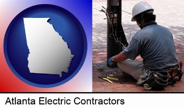 an electrician wearing a tool belt, installing electrical wiring in Atlanta, GA