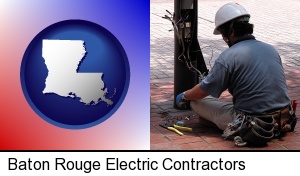 Baton Rouge, Louisiana - an electrician wearing a tool belt, installing electrical wiring