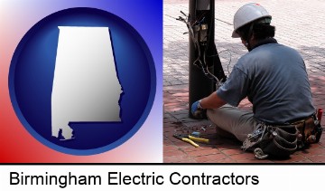 an electrician wearing a tool belt, installing electrical wiring in Birmingham, AL