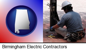 Birmingham, Alabama - an electrician wearing a tool belt, installing electrical wiring