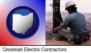 Cincinnati, Ohio - an electrician wearing a tool belt, installing electrical wiring
