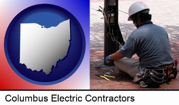an electrician wearing a tool belt, installing electrical wiring in Columbus, OH