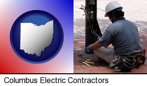 Columbus, Ohio - an electrician wearing a tool belt, installing electrical wiring