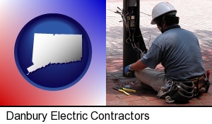 an electrician wearing a tool belt, installing electrical wiring in Danbury, CT