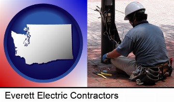 an electrician wearing a tool belt, installing electrical wiring in Everett, WA