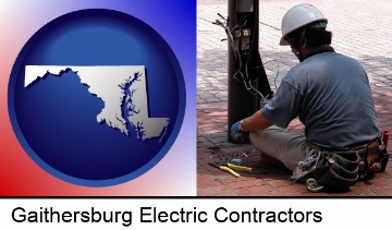 an electrician wearing a tool belt, installing electrical wiring in Gaithersburg, MD