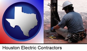 an electrician wearing a tool belt, installing electrical wiring in Houston, TX
