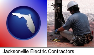 Jacksonville, Florida - an electrician wearing a tool belt, installing electrical wiring