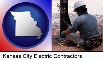 an electrician wearing a tool belt, installing electrical wiring in Kansas City, MO