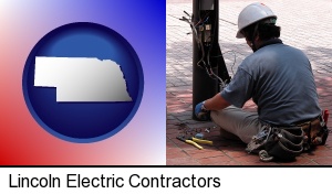 an electrician wearing a tool belt, installing electrical wiring in Lincoln, NE