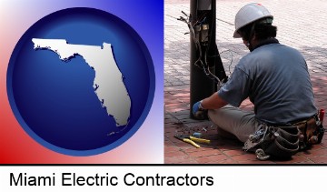 an electrician wearing a tool belt, installing electrical wiring in Miami, FL