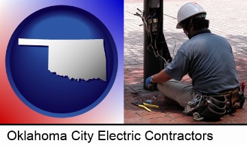 an electrician wearing a tool belt, installing electrical wiring in Oklahoma City, OK
