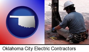 Oklahoma City, Oklahoma - an electrician wearing a tool belt, installing electrical wiring
