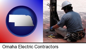 Omaha, Nebraska - an electrician wearing a tool belt, installing electrical wiring