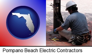 Pompano Beach, Florida - an electrician wearing a tool belt, installing electrical wiring