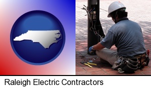 Raleigh, North Carolina - an electrician wearing a tool belt, installing electrical wiring