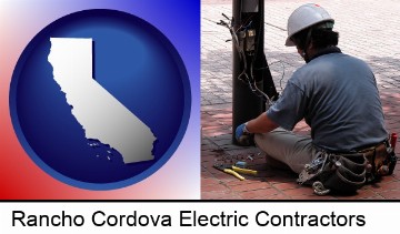 an electrician wearing a tool belt, installing electrical wiring in Rancho Cordova, CA