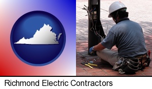 Richmond, Virginia - an electrician wearing a tool belt, installing electrical wiring