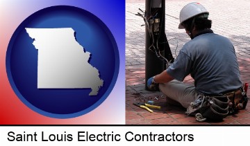 an electrician wearing a tool belt, installing electrical wiring in Saint Louis, MO