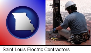 Saint Louis, Missouri - an electrician wearing a tool belt, installing electrical wiring