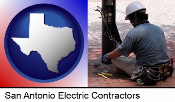 an electrician wearing a tool belt, installing electrical wiring in San Antonio, TX