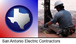 San Antonio, Texas - an electrician wearing a tool belt, installing electrical wiring