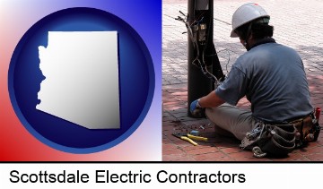 an electrician wearing a tool belt, installing electrical wiring in Scottsdale, AZ