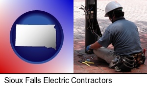 Sioux Falls, South Dakota - an electrician wearing a tool belt, installing electrical wiring