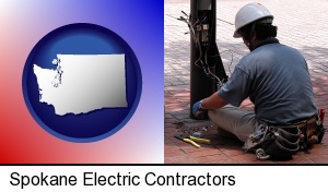 an electrician wearing a tool belt, installing electrical wiring in Spokane, WA
