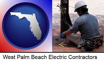 an electrician wearing a tool belt, installing electrical wiring in West Palm Beach, FL