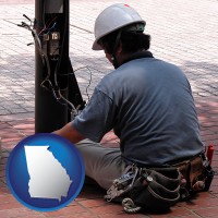 georgia map icon and an electrician wearing a tool belt, installing electrical wiring