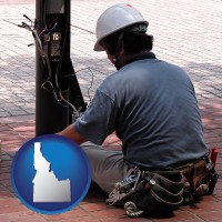 idaho map icon and an electrician wearing a tool belt, installing electrical wiring