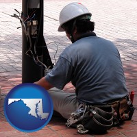 maryland map icon and an electrician wearing a tool belt, installing electrical wiring