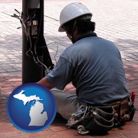 michigan map icon and an electrician wearing a tool belt, installing electrical wiring