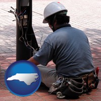north-carolina map icon and an electrician wearing a tool belt, installing electrical wiring