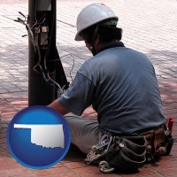 oklahoma map icon and an electrician wearing a tool belt, installing electrical wiring