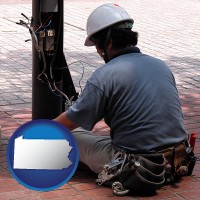 pennsylvania map icon and an electrician wearing a tool belt, installing electrical wiring