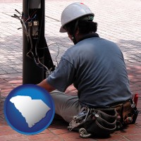 south-carolina map icon and an electrician wearing a tool belt, installing electrical wiring