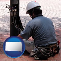 south-dakota map icon and an electrician wearing a tool belt, installing electrical wiring