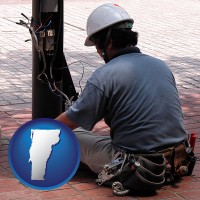 vermont map icon and an electrician wearing a tool belt, installing electrical wiring