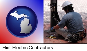 an electrician wearing a tool belt, installing electrical wiring in Flint, MI