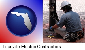 an electrician wearing a tool belt, installing electrical wiring in Titusville, FL