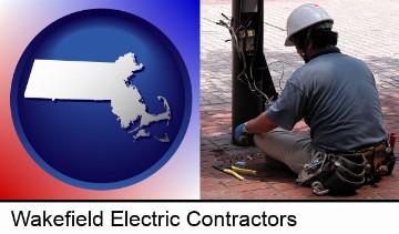 an electrician wearing a tool belt, installing electrical wiring in Wakefield, MA