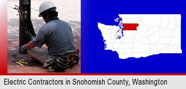 an electrician wearing a tool belt, installing electrical wiring; Snohomish County highlighted in red on a map